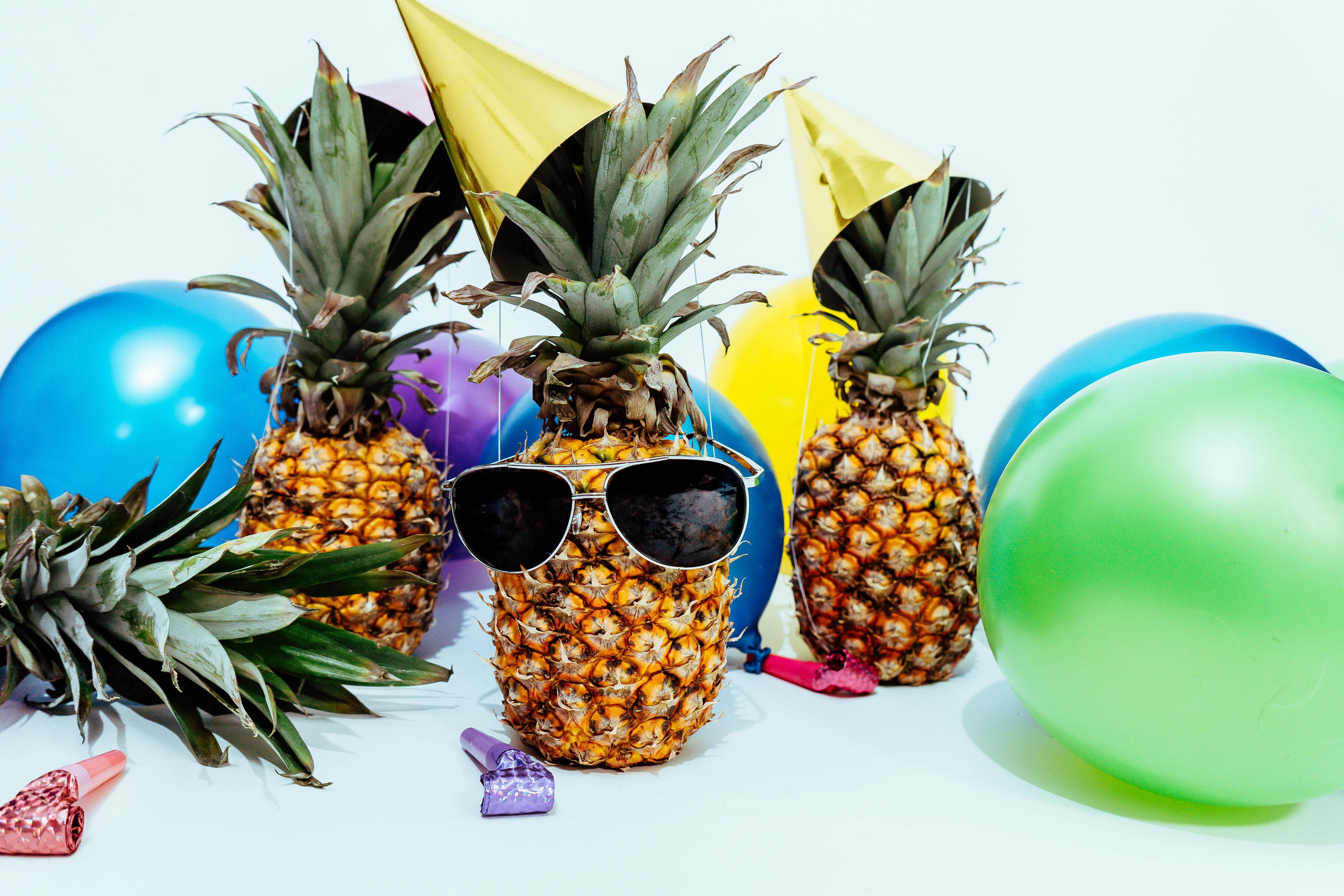 3 pineapples surrounded by party elements to indicate celebrating the three webinars
