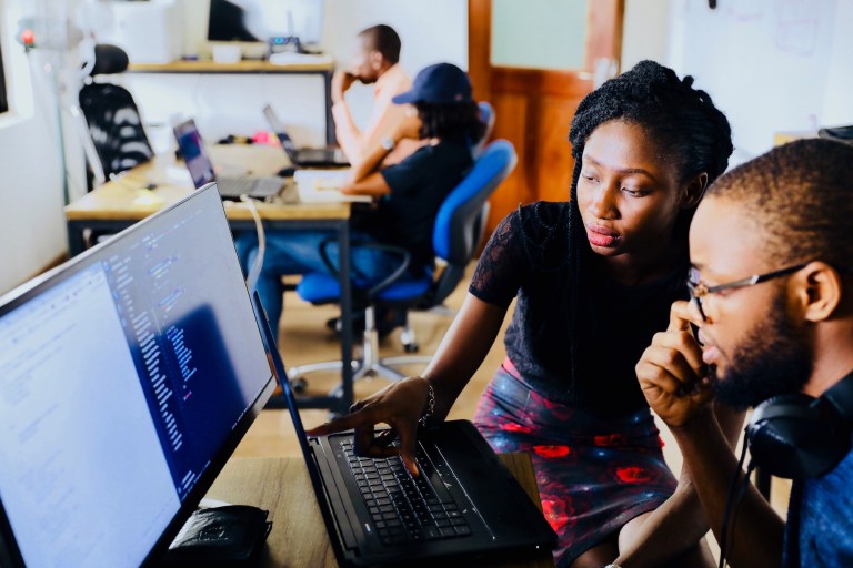 Man and woman in front of a computer